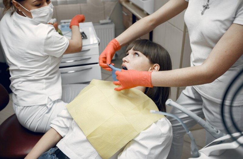 dentist replace tooth of her clients