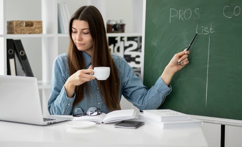 a woman with cup and pen